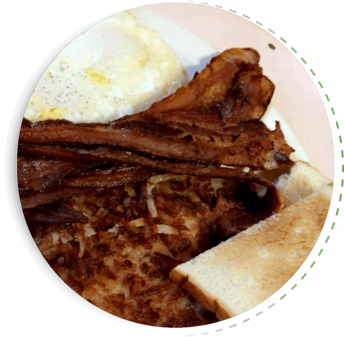 A plate with fried eggs, bacon, and toasted bread.